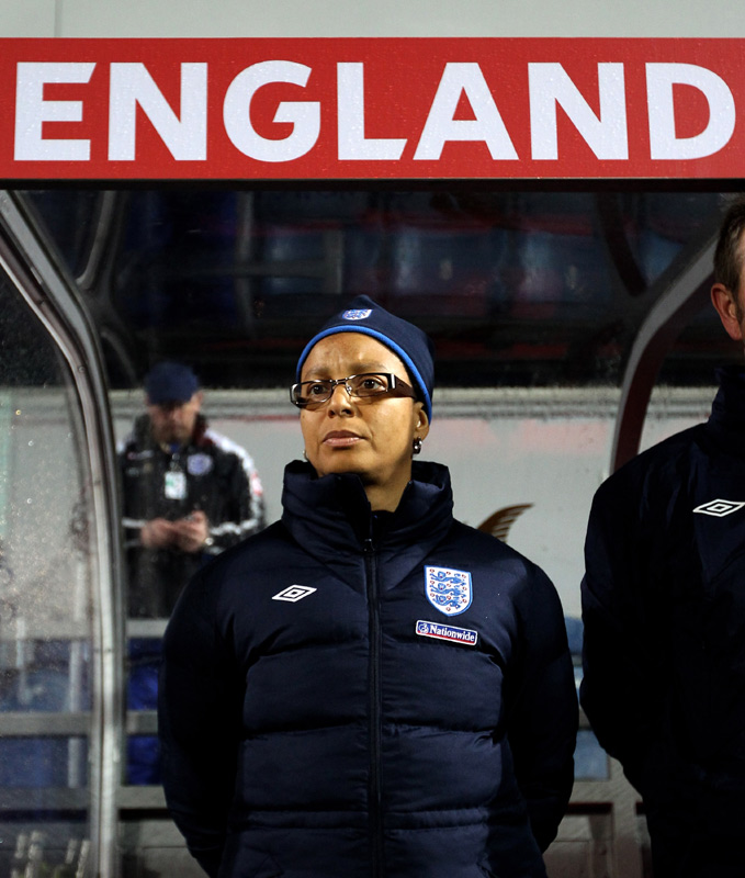 Hope Powell watches on from the England dugout.